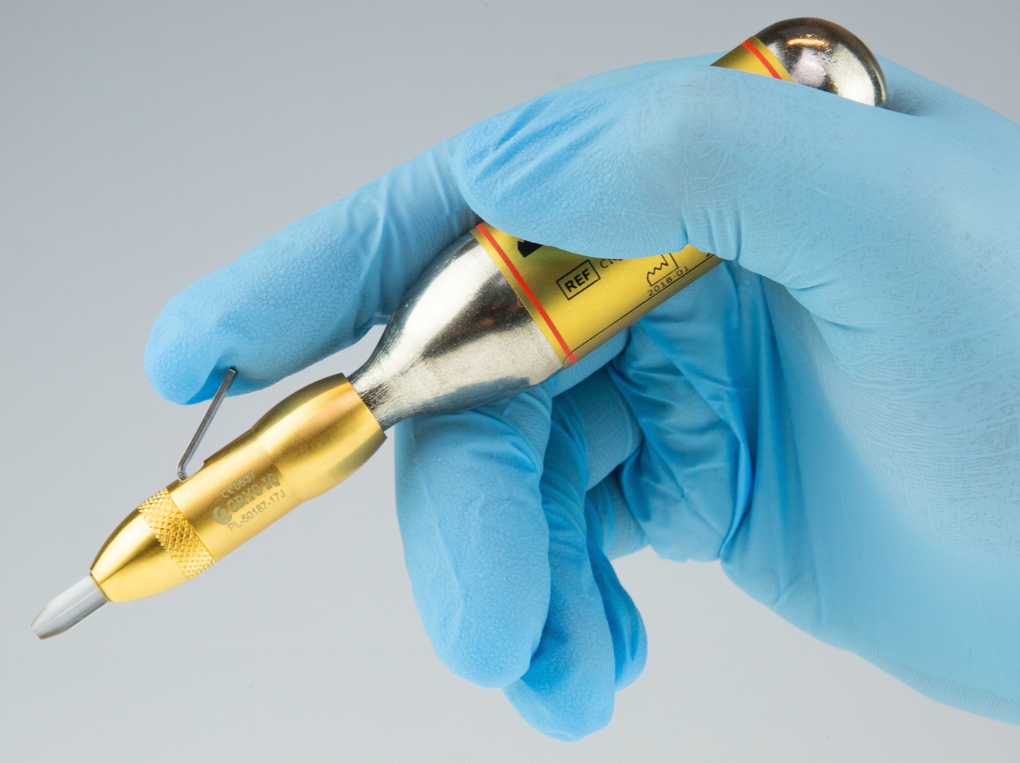 Cryotherapy treatment pen held during a procedure